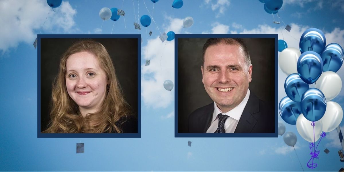 Image of two solicitors with blue and white balloons in the background.