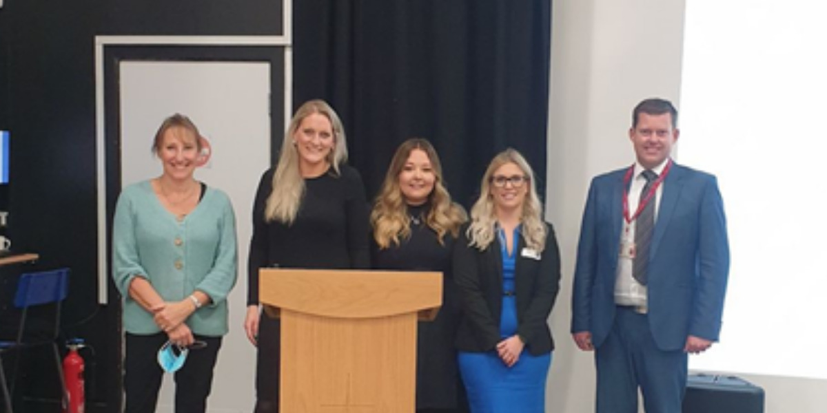 Group of Gordons employees standing behind an altar at an event.