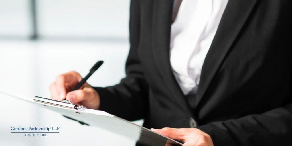 Business man writing on a clipboard
