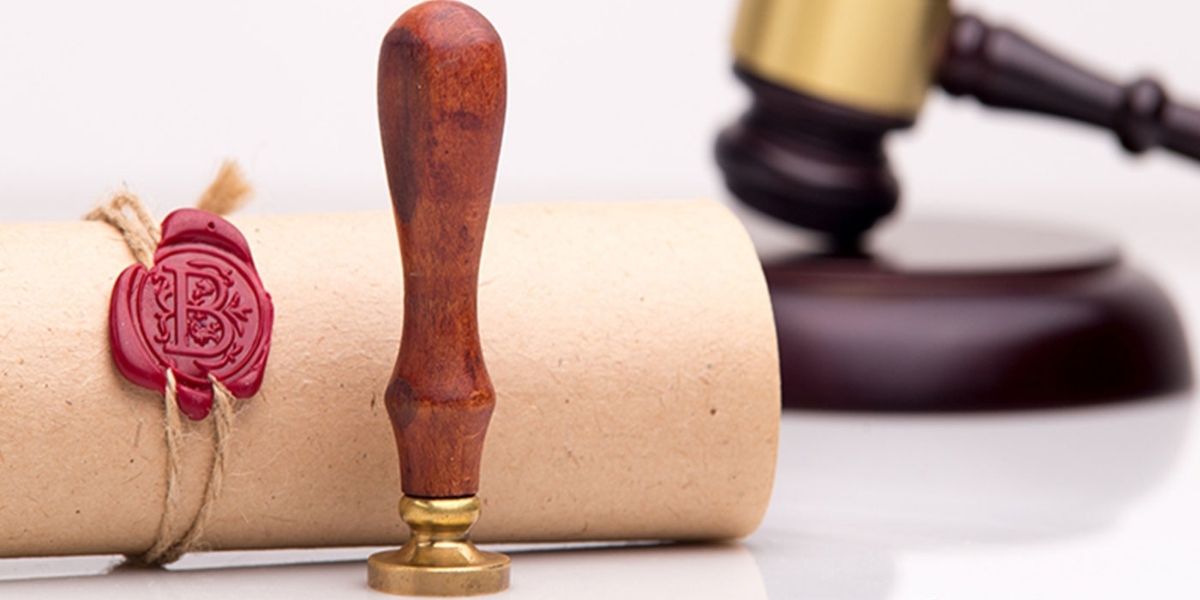 Letter with a seal and a gavel in the background.