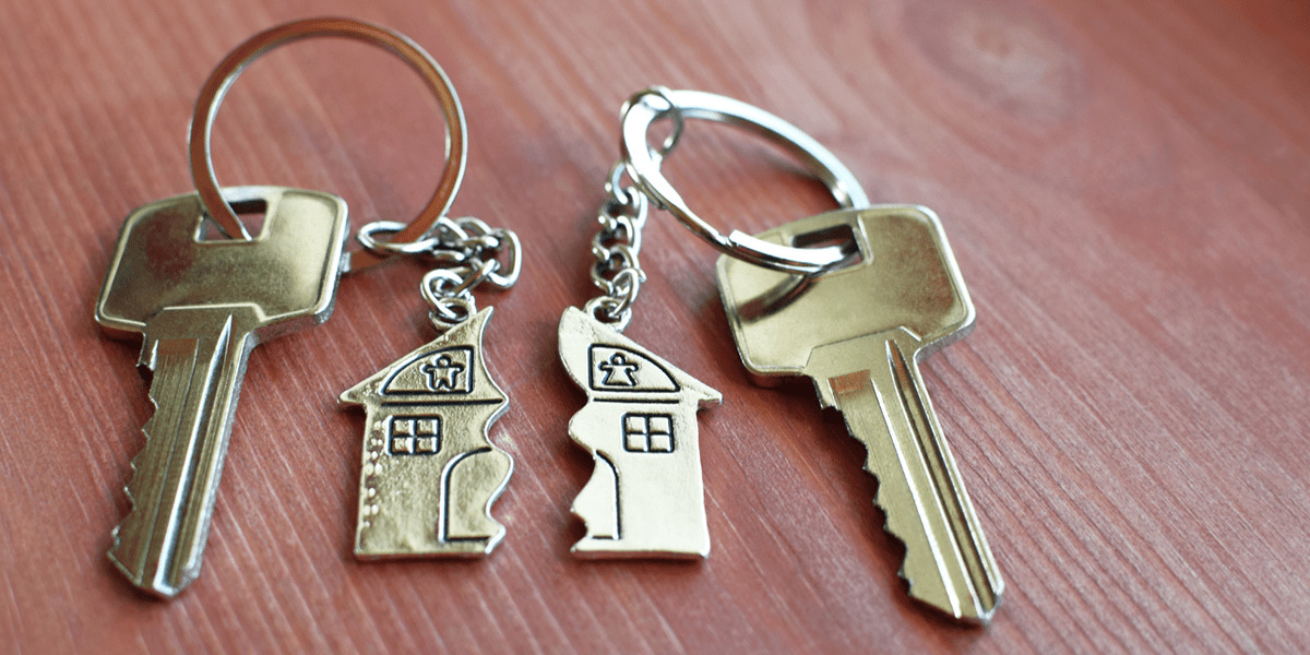 Two keys with one half of a house attached to each,