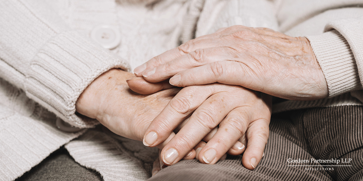Old couple holding hands
