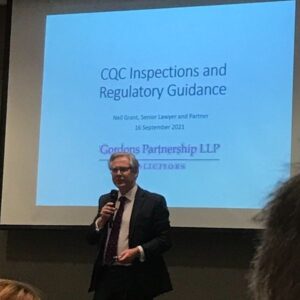 Man giving a presentation on CQC Inspections and Regulatory Guidance