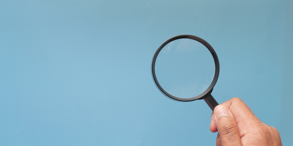 Magnifying glass on a blue background
