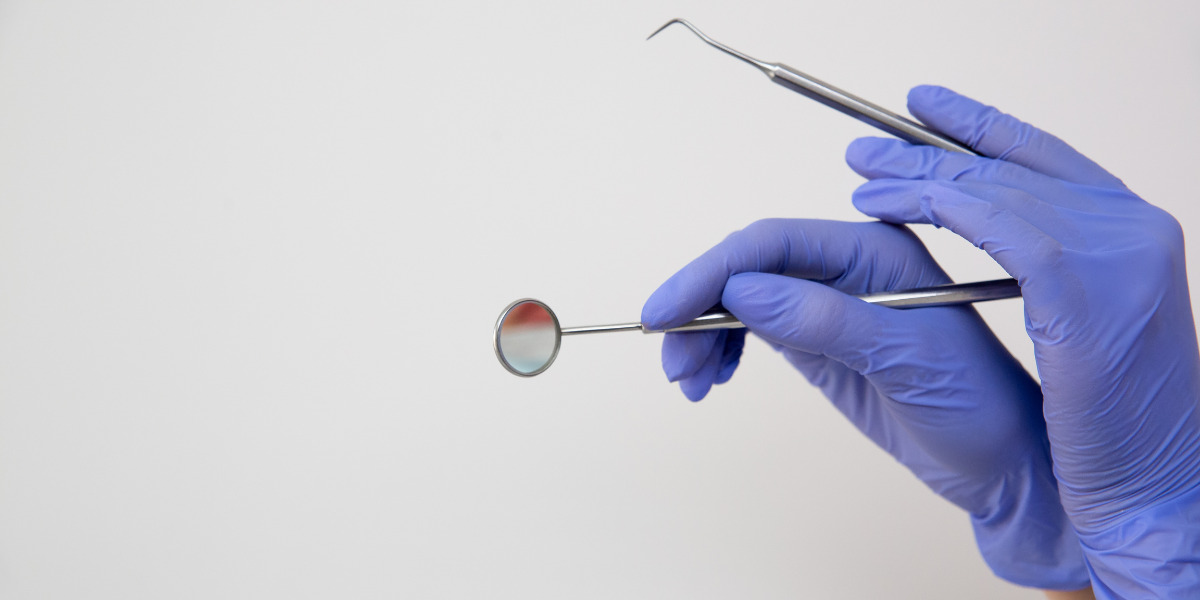Surgical gloves holding dentist equipment