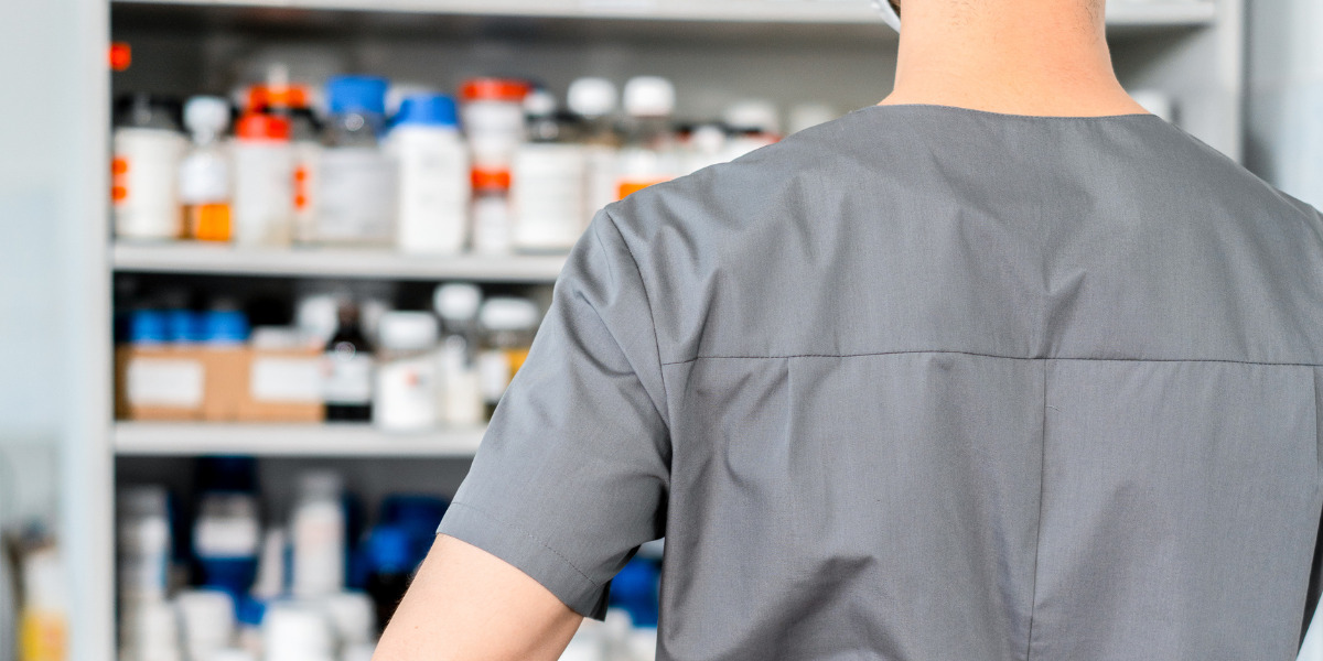 Man looking at a medicine shelf.