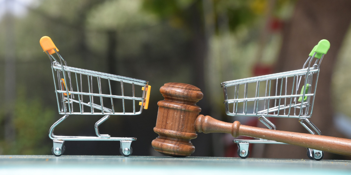Two miniature shopping carts and a gavel.