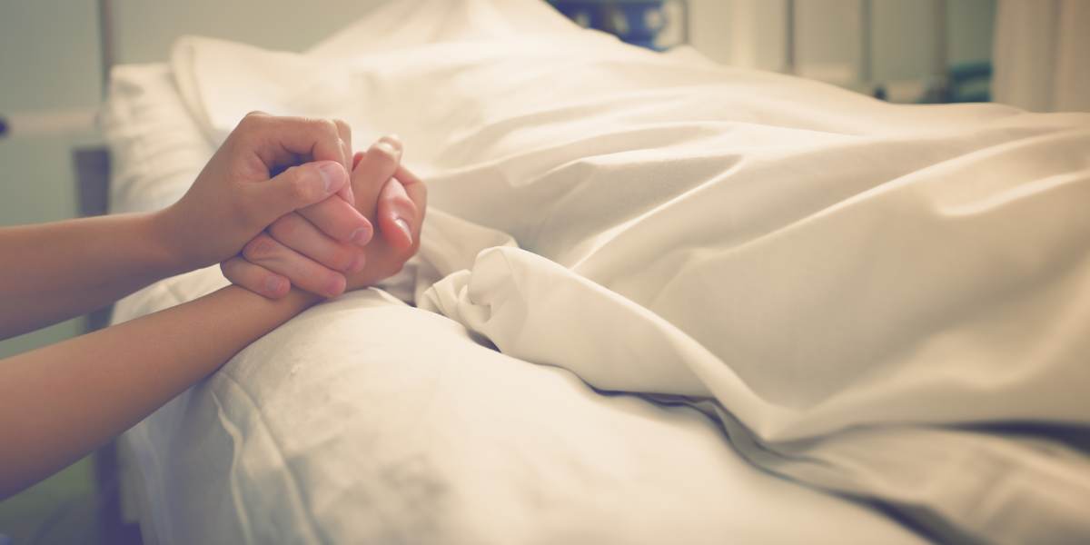 Woman mourns her husband, who died in a hospital
