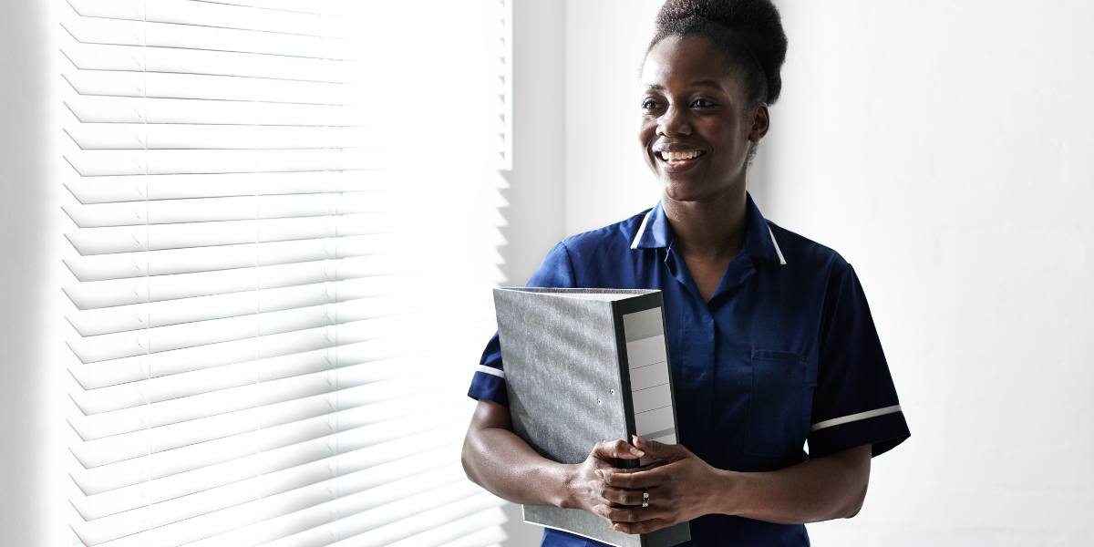Nurse with file smiling